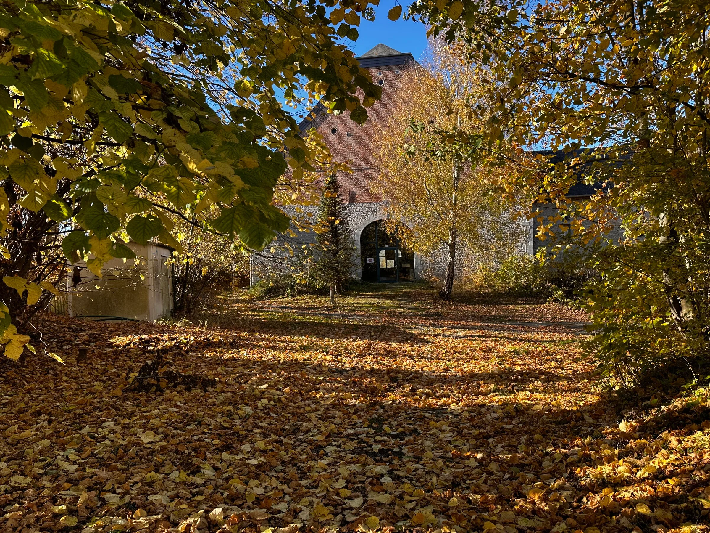 The historic Hulplanche farm in autumn, in La Bruyère